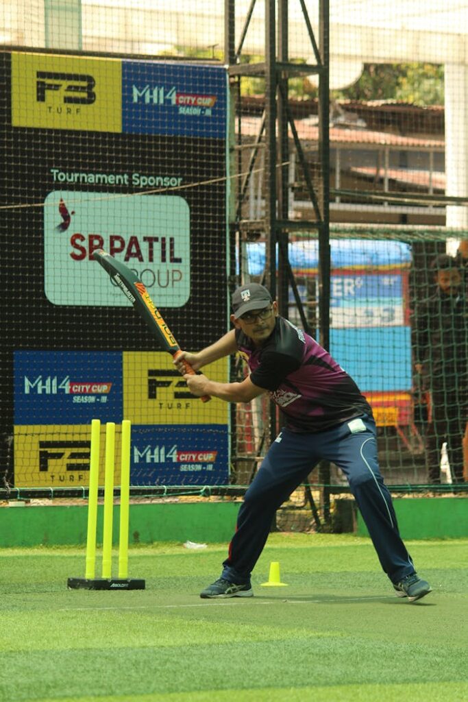 Exciting cricket action as a batsman prepares to strike on a vibrant turf field.